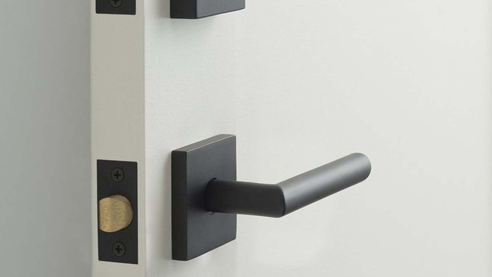 White residential deadbolt lock and latch mechanism on a door, part of a home security upgrade in Algonquin.